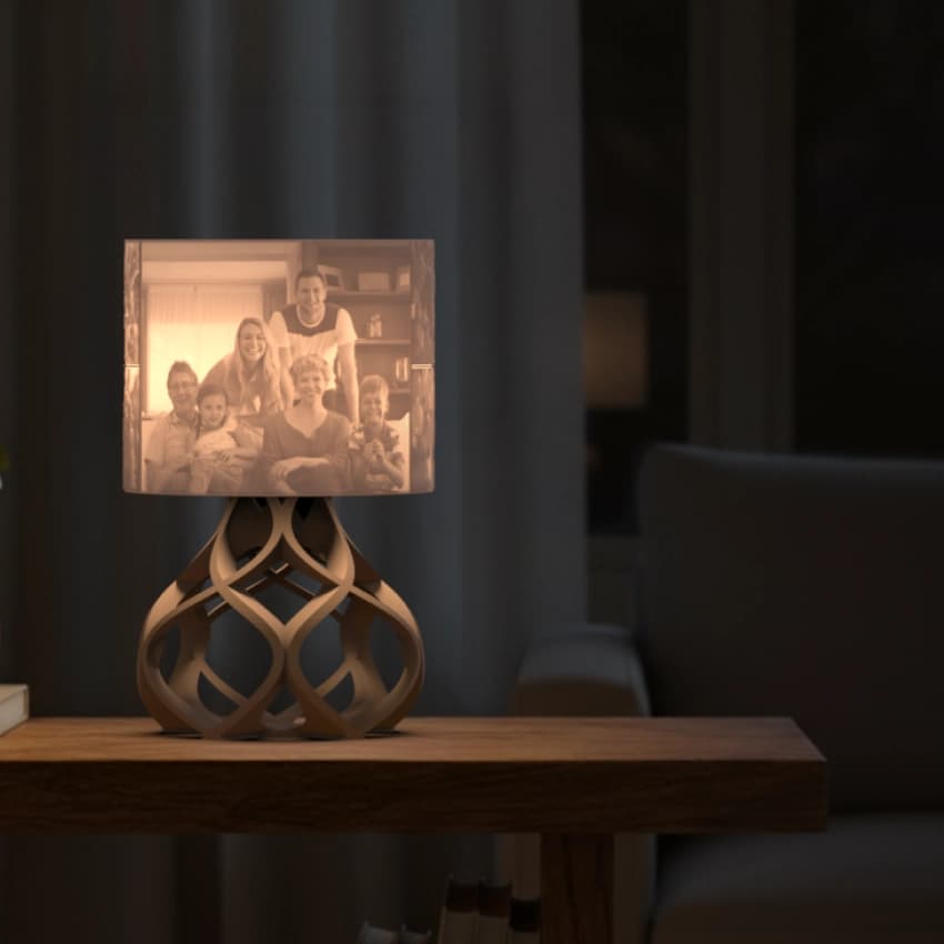 Aurora Personalized 3D printed photo lamp glowing warmly on a wooden table in a cozy living room.